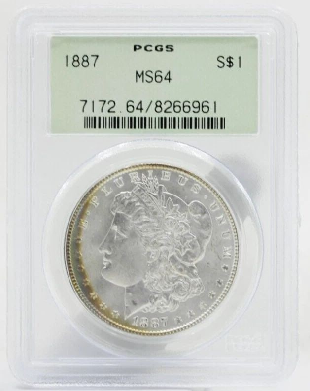 1887 MORGAN SILVER DOLLAR $1 PCGS MS64 OLD GREEN HOLDER: 1887 MORGAN SILVER DOLLAR $1 PCGS MS64 OLD GREEN HOLDER Description 1887 Morgan Silver Dollar $1 PCGS MS64 Old Green Holder Coins has been graded as a MS-64 by NGC. The protective plastic holder may s
