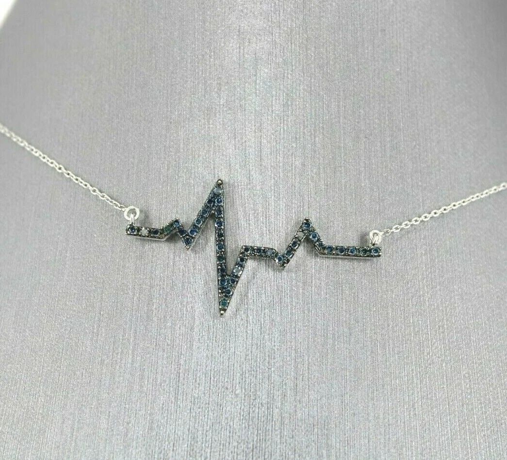 STERLING SILVER 0.33 TCW BLUE DIAMOND HEARTBEAT PENDANT NECKLACE, 3.3 GRAMS: STERLING SILVER 0.33 TCW BLUE DIAMOND HEARTBEAT PENDANT NECKLACE, 3.3 GRAMS STERLING SILVER 0.33 TCW BLUE DIAMOND HEARTBEAT PENDANT NECKLACE, 3.3 GRAMS Description Sterling Silver 0.33 TCW Blue Diamon