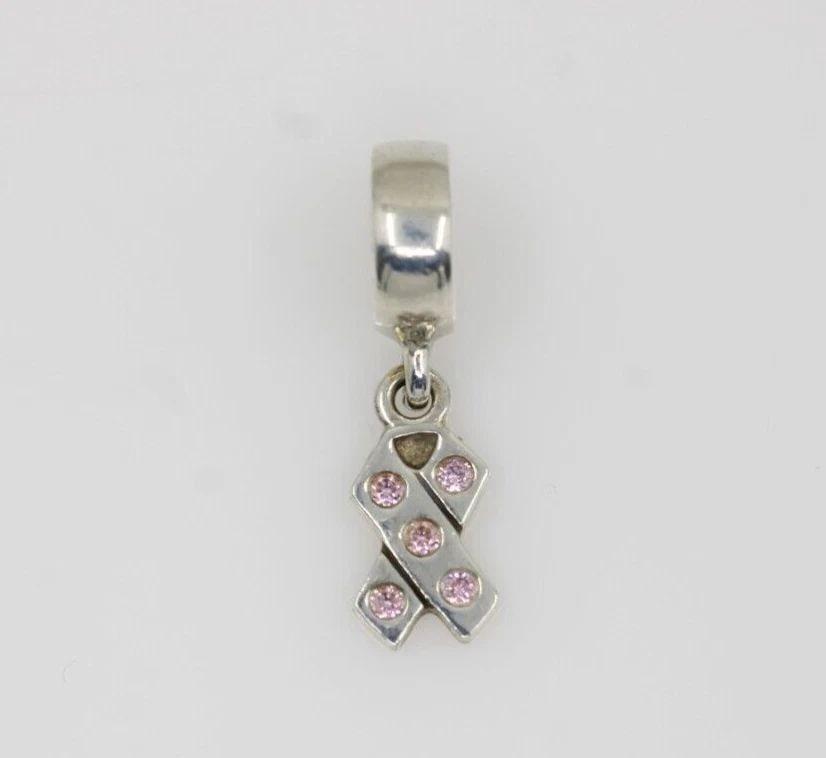 AUTHENTIC PANDORA STERLING SILVER BREAST CANCER DANGLE CHARM #790314CZ: AUTHENTIC PANDORA STERLING SILVER BREAST CANCER DANGLE CHARM #790314CZ Description Authentic Pandora Sterling Silver Breast Cancer Dangle Charm #790314CZ "Two charms available. One charm per purchase 