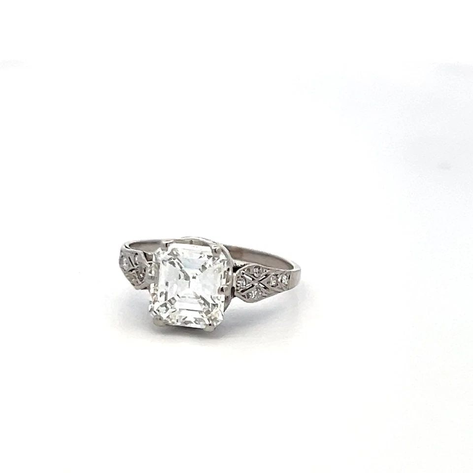 2.01 CARAT EMERALD CUT F SI1 DIAMOND PLATINUM VINTAGE ENGAGEMENT RING GIA: 2.01 CARAT EMERALD CUT F SI1 DIAMOND PLATINUM VINTAGE ENGAGEMENT RING GIA Title: This stunning vintage engagement ring showcases a 2.01 carat emerald cut diamond, graded F color and SI1 clarity by GIA