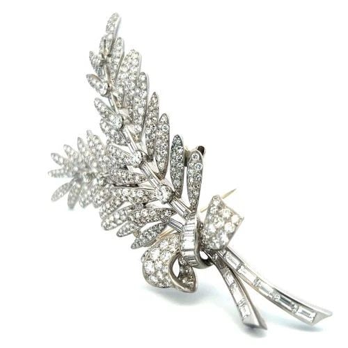 VINTAGE PLATINUM PIN BROOCH WITH 12.05 CARAT ROUND AND TAPERED BAGUETTE DIAMONDS: VINTAGE PLATINUM PIN BROOCH WITH 12.05 CARAT ROUND AND TAPERED BAGUETTE DIAMONDS Detailed Description: 9.5 Carat H VS Round Brilliant Elevate your collection with this striking vintage platinum pin br