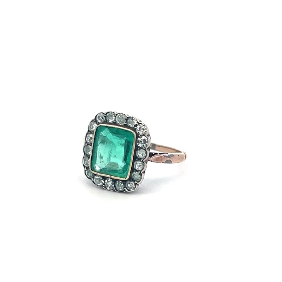10K TWO TONE EDWARDIAN RING WITH 0.9 CT. OLD EUROPEAN DIAMOND & 1.5 CT. EMERALD: 10K TWO TONE EDWARDIAN RING WITH 0.9 CT. OLD EUROPEAN DIAMOND & 1.5 CT. EMERALD Detailed Description: 10K Gold, Size 5.25 Delight in timeless elegance with this antique Edwardian ring, showcasing a ca