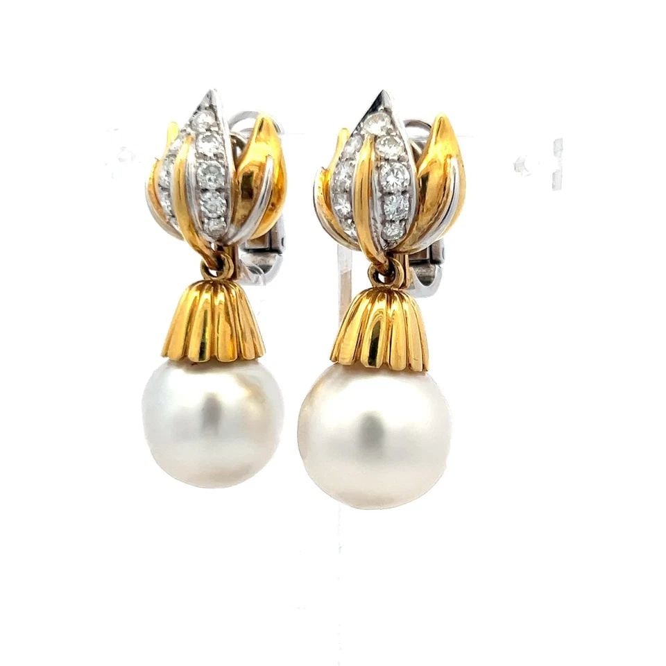 VINTAGE 18K GOLD DROP EARRINGS WITH 1 CARAT ROUND DIAMONDS & SOUTH SEA PEARLS: VINTAGE 18K GOLD DROP EARRINGS WITH 1 CARAT ROUND DIAMONDS & SOUTH SEA PEARLS Detailed Description: Embrace timeless elegance with these vintage earrings, crafted in 18 karat yellow gold. Each earring
