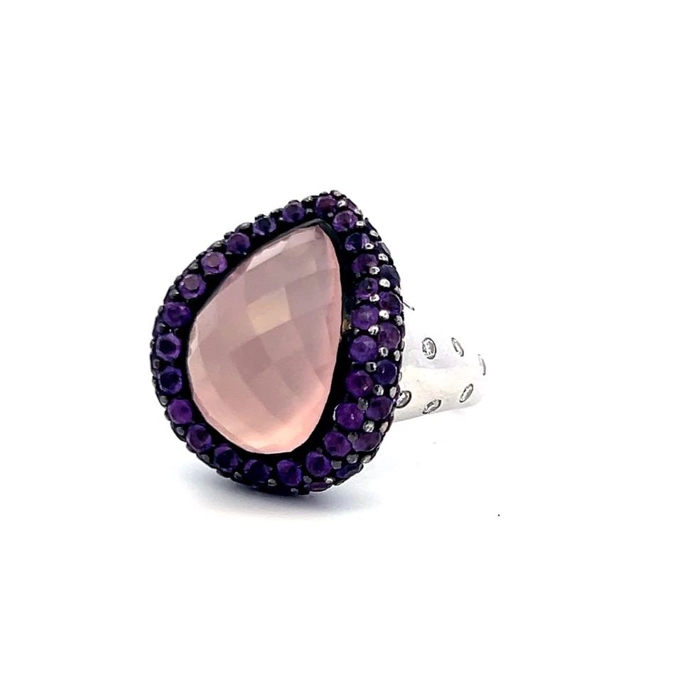 TEARDROP ROSE QUARTZ 18K WHITE GOLD COCKTAIL RING 0.21 CARAT DIAMONDS SAPPHIRE: TEARDROP ROSE QUARTZ 18K WHITE GOLD COCKTAIL RING 0.21 CARAT DIAMONDS SAPPHIRE Detailed Description: Elevate your style with a vintage and estate cocktail ring featuring a striking teardrop-shaped ros