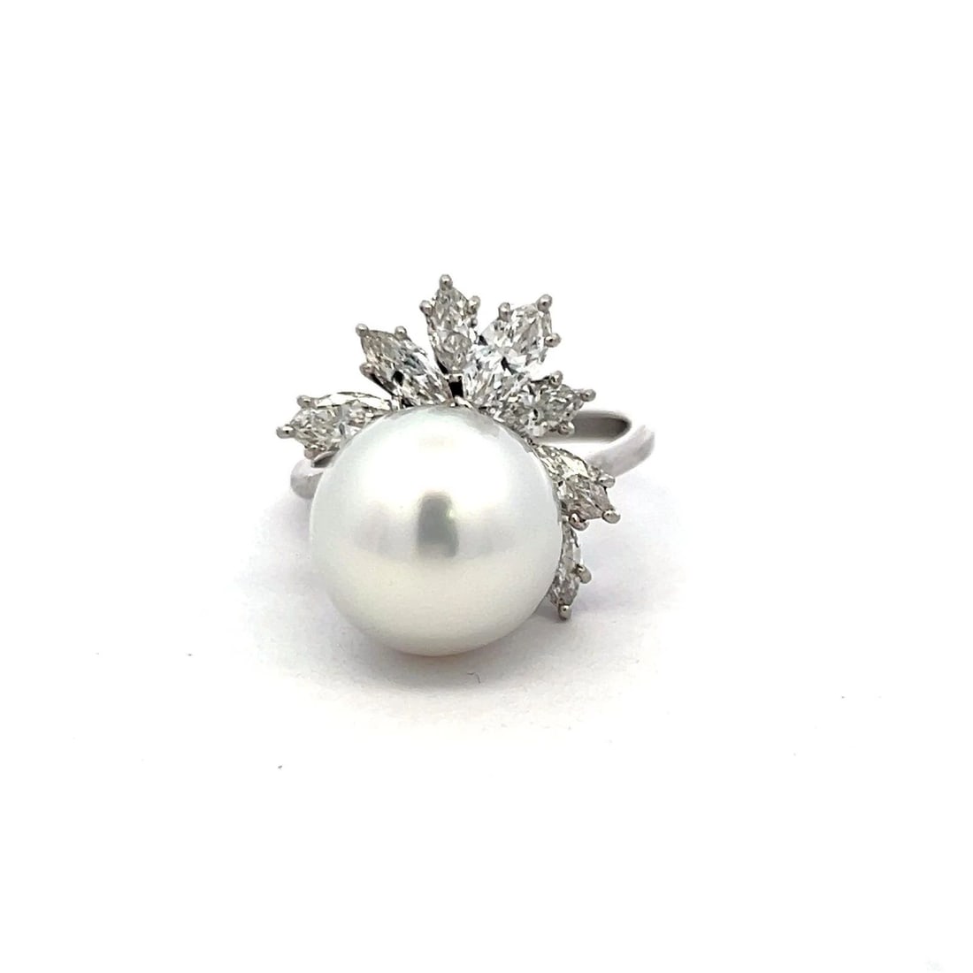 PLATINUM COCKTAIL RING WITH 1.4 CARAT MARQUIS DIAMONDS & 12.1-12.7 MM PEARL: PLATINUM COCKTAIL RING WITH 1.4 CARAT MARQUIS DIAMONDS & 12.1-12.7 MM PEARL Video: Video Link Detailed Description: In the gentle embrace of platinum, a lustrous pearl, measuring 12.1-12.7mm, radiates