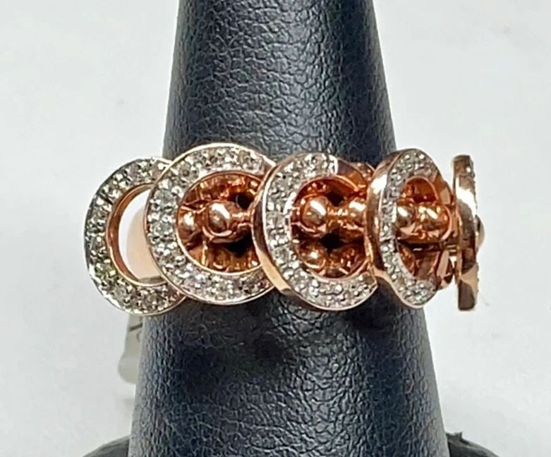 NEW 14K ROSE GOLD RING WITH DIAMONDS AND 5 ROSE GOLD HOOPS THAT MOVE FREELY: 14K ROSE GOLD RING WITH DIAMONDS AND 5 ROSE GOLD HOOPS THAT MOVE FREELY 14k Rose Gold Ring with Diamonds and 5 Rose Gold Hoops That Move Freely You are bidding on a new with defects 14k Rose Gold Ring