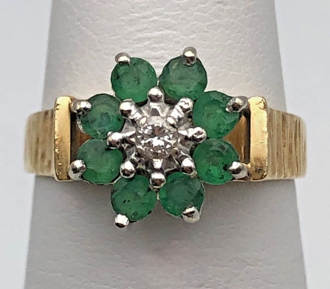 14K GOLD FLOWER RING WITH NATURAL EMERALDS AND DIAMONDS (SIZE 5.75) 3.8 GRAMS: 14K GOLD FLOWER RING WITH NATURAL EMERALDS AND 0.04CTS DIAMONDS SIZE: 5.75 14k Gold Flower style Ring with Emeralds and 0.04cts of Diamonds Condition: Used Material: 14k Yellow Gold Ring Size: 5.75 We
