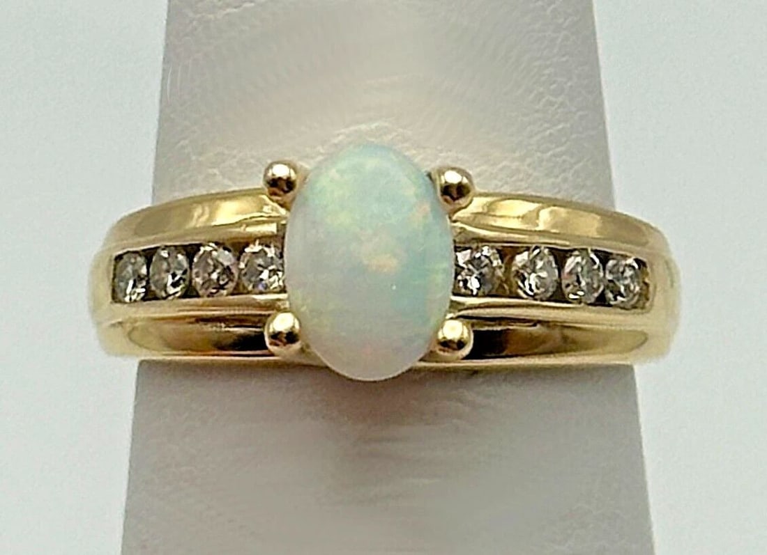 10K GOLD RING WITH NATURAL OPAL AND 0.16CTW DIAMONDS (SIZE 5) 2.9 GRAM: 10K GOLD RING WITH NATURAL OPAL AND 0.16CTS OF DIAMONDS SIZE: 5 10k Gold Ring with natural Opal and 0.16cts of Diamonds Condition: Used Material: 10k Yellow Gold Ring Size: 5 Weight: 2.9 grams Top Wid