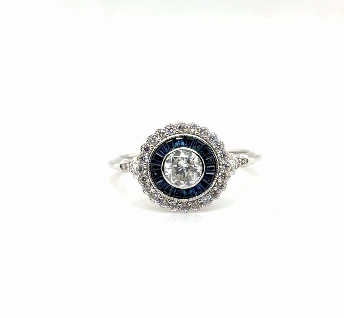 .45CT DIAMOND AND BLUE SAPPHIRE RING IN 14 WHITE GOLD: .45CT DIAMOND AND BLUE SAPPHIRE RING IN 14 WHITE GOLD Elevate your look with this stunning Unisex ring crafted in 14K white gold Featuring a captivating round cut diamond weighing 43ct F vvs2 as the c