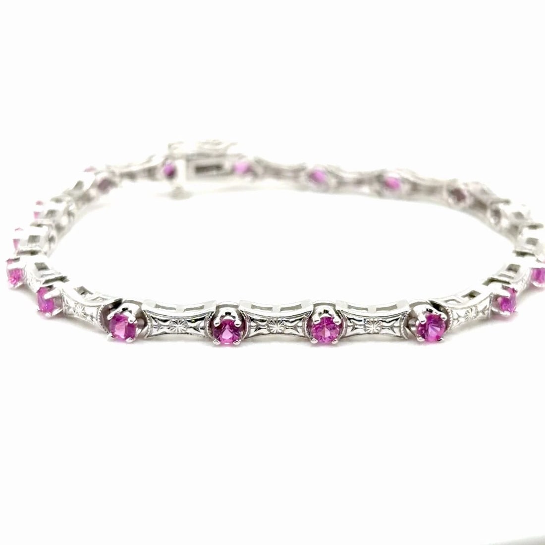 PINK SAPPHIRE BRACELET IN 14K WHITE GOLD WITH APPROXIMATELY 2.15CTS OF SAPPHIRE: PINK SAPPHIRE BRACELET IN 14K WHITE GOLD WITH APPROXIMATELY 2.15CTS OF SAPPHIRE This stunning bracelet features approximately 2 15 carats of Synthetic pink sapphires a set in 14k white gold The vibran