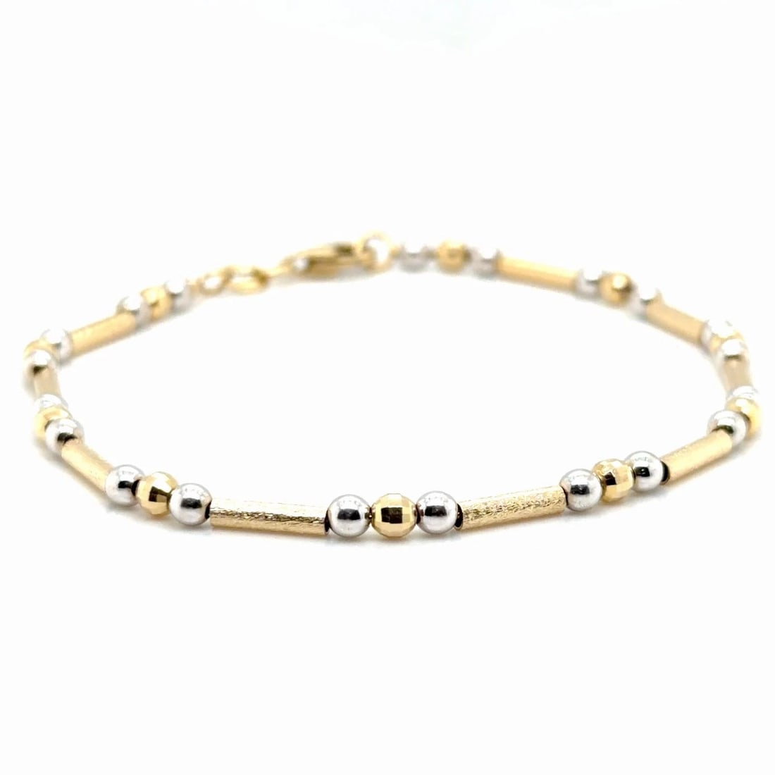 14CT WHITE AND YELLOW GOLD 5G TEXTURED BRACELET: 14CT WHITE AND YELLOW GOLD 5G TEXTURED BRACELET This stunning two-tone 14k Gold Bracelet features three styles of gold beads, textured long yellow gold tubes, white gold smooth balls and facated round