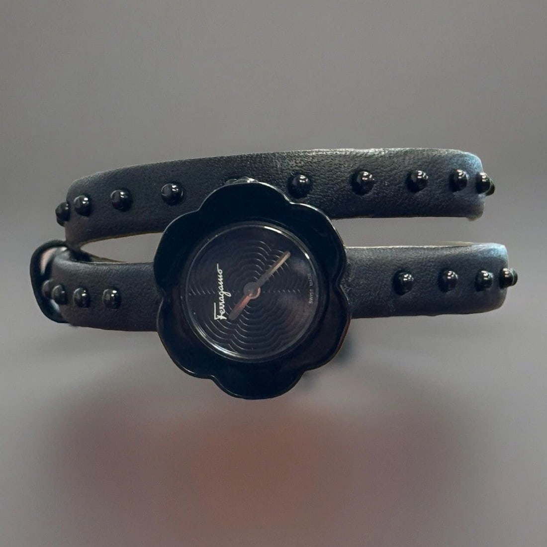 SALVATORE FERRAGAMO FIORE WATCH: SALVATORE FERRAGAMO FIORE WATCH Salvatore Ferragamo Fiore Watch Sapphire Crystal Quartz Movement Retail New: $995 Black Plated Stainless Steel Case and Bezel Black Leather Calfskin, Ball Studded Strap