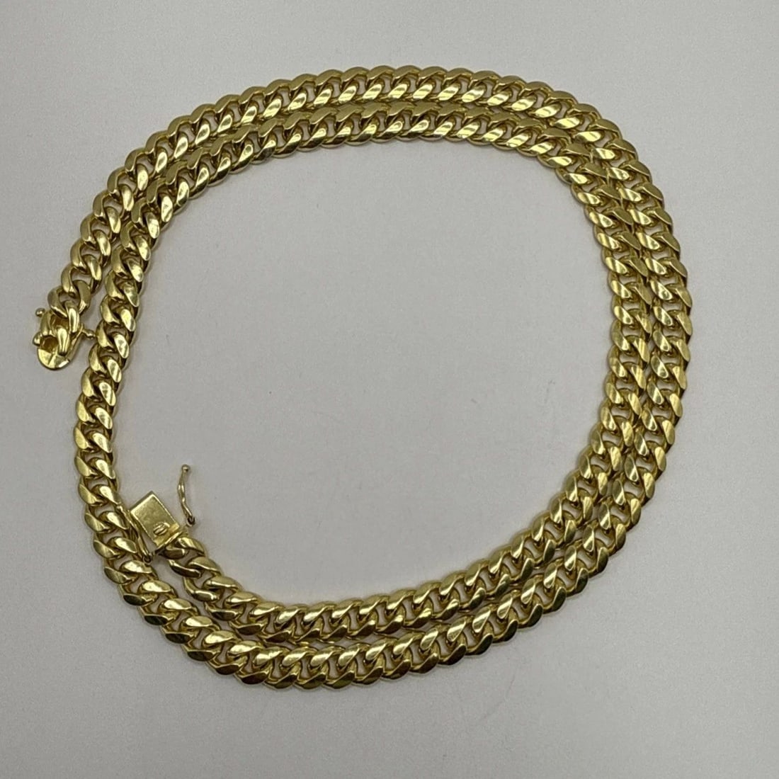STERLING SILVER GOLD COLOR NECKLACE 24" CUBAN LINK: STERLING SILVER GOLD COLOR NECKLACE 24" CUBAN LINK STERLING SILVER GOLD COLOR NECKLACE 24" CUBAN LINK Elevate your accessory game with this sophisticated Sterling Silver Gold Color Necklace. Featuring