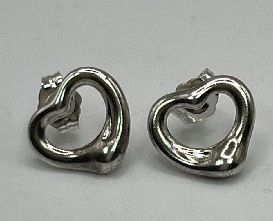 TIFFANY & CO. STERLING SILVER ELSA PERETTI OPEN HEART STUD EARRINGS: TIFFANY & CO. STERLING SILVER ELSA PERETTI OPEN HEART STUD EARRINGS TIFFANY & CO. STERLING SILVER ELSA PERETTI OPEN HEART STUD EARRINGS Add a touch of elegance to your outfit with these stunning Tiffa