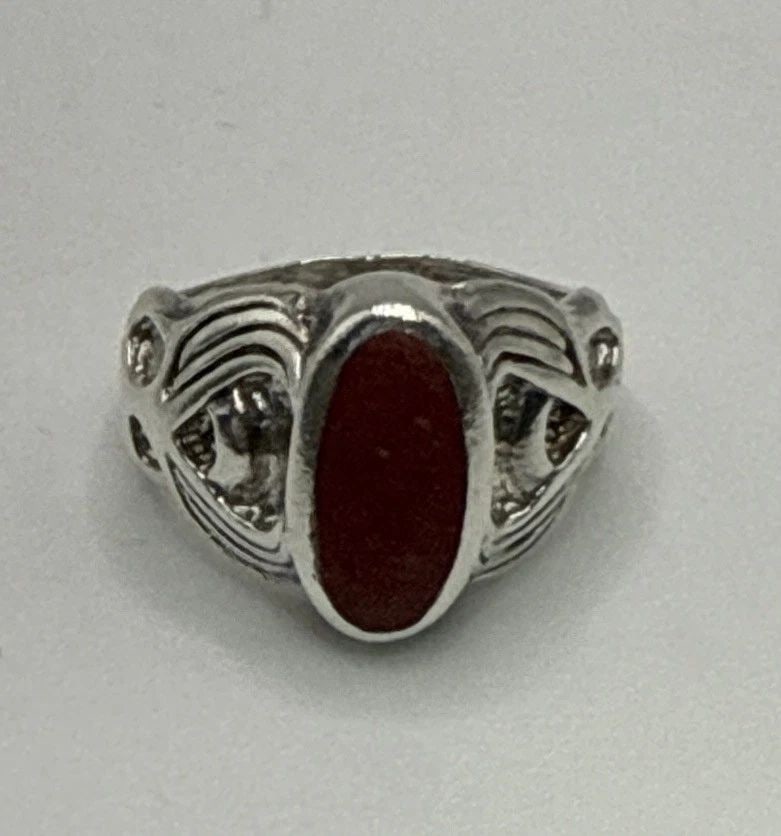STERLING SILVER WITH HONED RED STONE SIZE 5: STERLING SILVER WITH HONED RED STONE SIZE 5 5.9 grams This sterling silver ring with a honed red stone is a beautiful and elegant piece of fine jewelry. The ring size is 5, and it is made with 925 ste