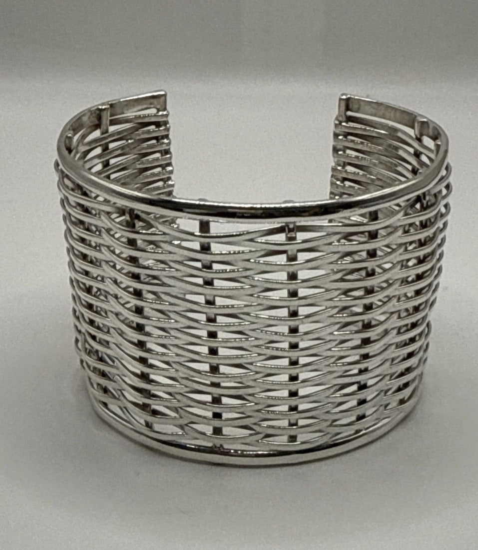 WIDE STERLING SILVER WIDE CUFF CUFF BRACELET 65.4 GRAMS: WIDE STERLING SILVER WIDE CUFF CUFF BRACELET 65.4 GRAMS This wide sterling silver cuff bracelet weighs 65.4 grams and is crafted from 925 sterling silver. The cuff style gives it a modern and bold loo