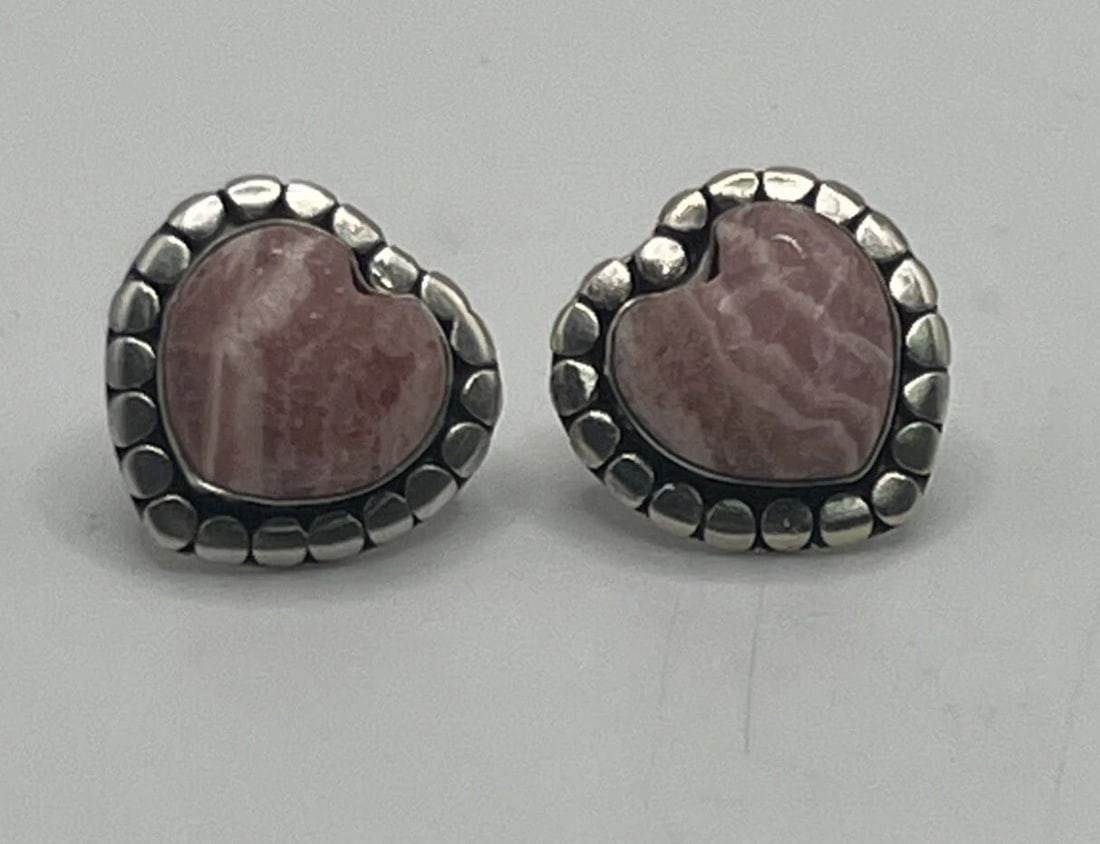 STERLING SILVER WITH PINK STONE HEART STUD EARRINGS: STERLING SILVER WITH PINK STONE HEART STUD EARRINGS STERLING SILVER WITH PINK STONE HEART STUD EARRINGS The "Sterling Silver with Pink Stone Heart Stud Earrings" features a heart-shaped design with a 
