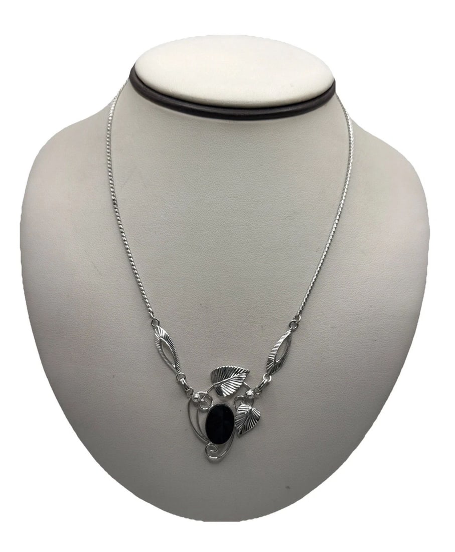 STERLING SILVER & ONYX 16" NECKLACE: STERLING SILVER & ONYX 16" NECKLACE This Sterling Silver & Onyx 16" Necklace features a bold statement style with a sleek metal purity of 925 sterling silver. The main stone is a striking black onyx, 