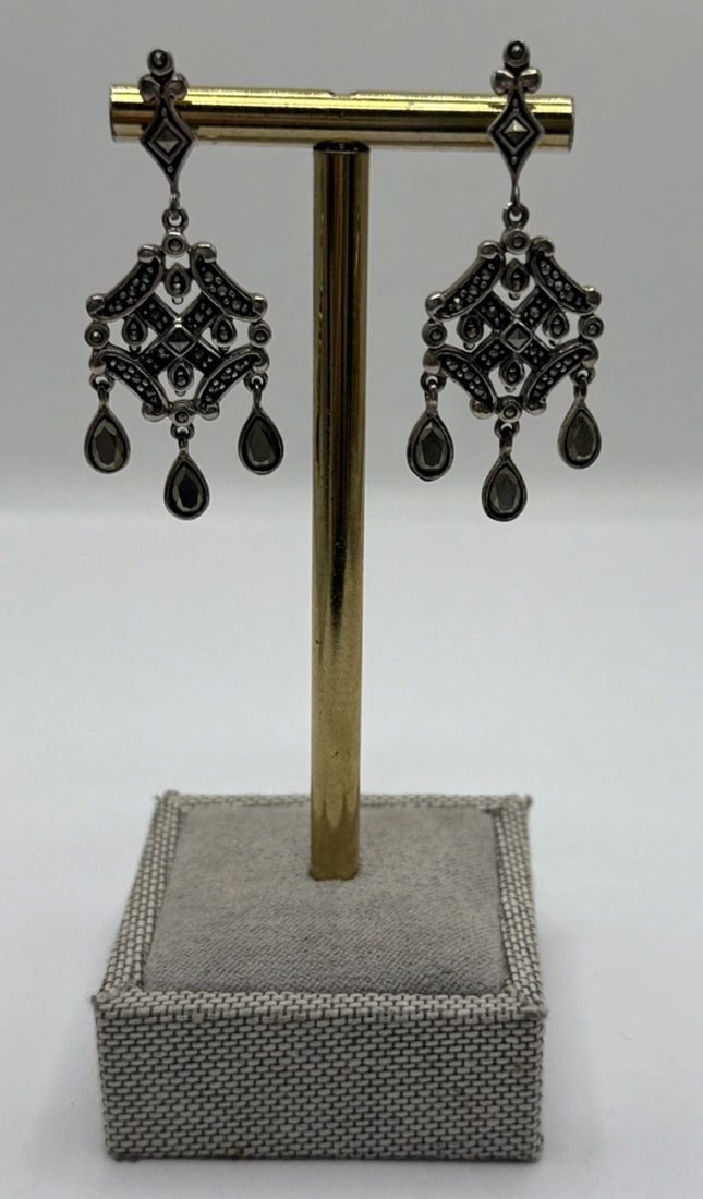 STERLING SILVER & MARCASITE DANGLE DROP EARRINGS: STERLING SILVER & MARCASITE DANGLE DROP EARRINGS STERLING SILVER & MARCASITE DANGLE DROP EARRINGS Elevate your ensemble with these elegant Sterling Silver & Marcasite Dangle Drop Earrings. Featuring a