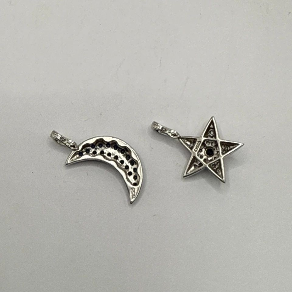 STERLING SILVER MOON AND STAR CHARMS WITH BLUE AND COLORLESS STONES: STERLING SILVER MOON AND STAR CHARMS WITH BLUE AND COLORLESS STONES This product is a set of sterling silver moon and star charms adorned with blue and colorless stones. Each charm is made of high-qua