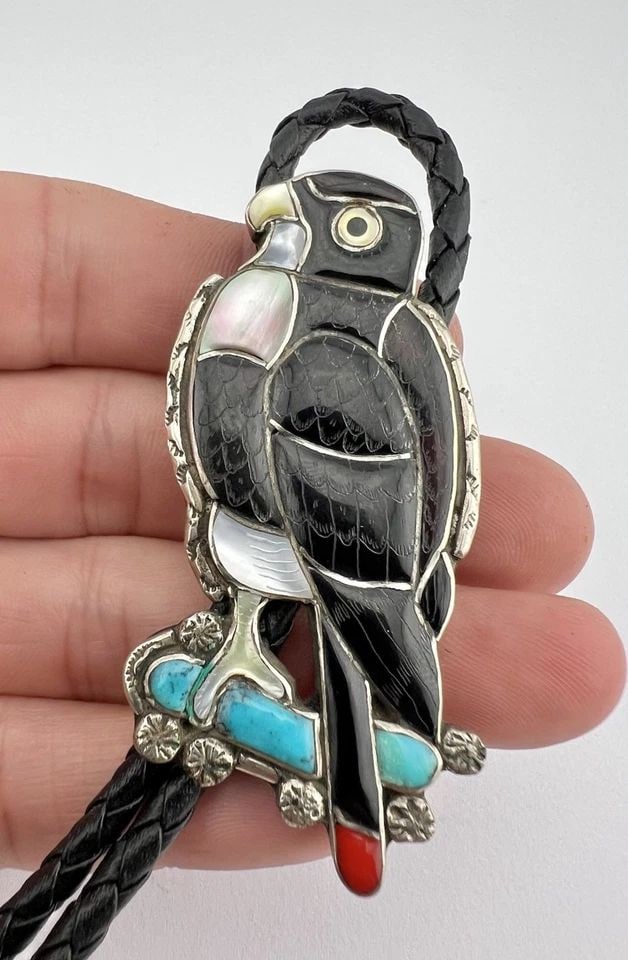 VINTAGE ZUNI PORFILIO SHEYKA CARVED MOSAIC GEMSTONE EAGLE BOLO TIE 2.5": VINTAGE ZUNI PORFILIO SHEYKA CARVED MOSAIC GEMSTONE EAGLE BOLO TIE 2.5" VINTAGE ZUNI PORFILIO SHEYKA CARVED MOSAIC GEMSTONE EAGLE BOLO TIE 2.5" Size: 2 1/2" Tall by 1 1/4" Wide Weight is 38.8 Grams on