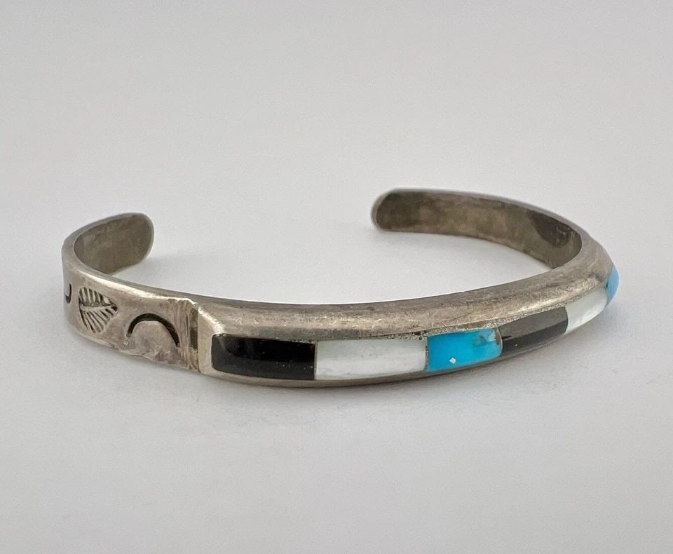 VTG NAVAJO STERLING SILVER TURQUOISE JET MOTHER OF PEARL STAMPED CUFF BRACELET: VTG NAVAJO STERLING SILVER TURQUOISE JET MOTHER OF PEARL STAMPED CUFF BRACELET Vtg Navajo Sterling Silver Turquoise Jet Mother Of Pearl Stamped Cuff Bracelet Cuff is 5" tip to Tip and has a 1 3/8" Wid