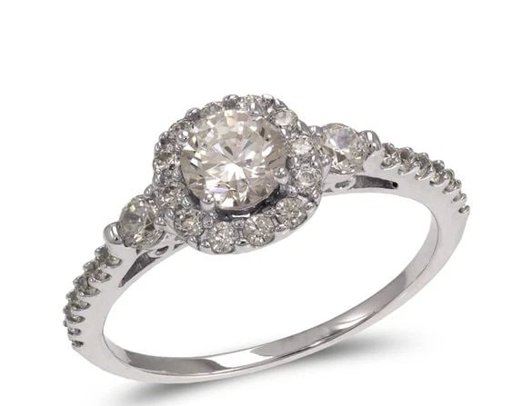 NEW 14K WHITE GOLD LADIES FANCY WHITE SOLITAIRE HALO RING: NEW 14K WHITE GOLD LADIES FANCY WHITE SOLITAIRE HALO RING LADIES FANCY WHITE SOLITAIRE HALO RING NEW 14K WHITE GOLD Apx. WIDTH: 5mm Apx. WEIGHT: 3.0g