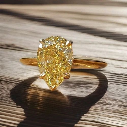 14K YELLOW GOLD ENGAGEMENT RING 3.51CT. NATURAL PEAR CUT YELLOW DIAMOND GIA CERT: 14K YELLOW GOLD ENGAGEMENT RING 3.51CT. NATURAL PEAR CUT YELLOW DIAMOND GIA CERT This exquisite 14k yellow gold engagement ring is a true masterpiece. The ring features a stunning 3.51CT natural pear 