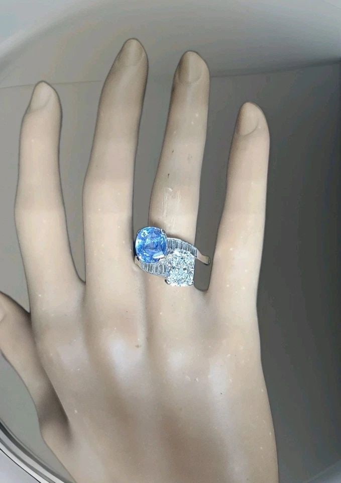 VINTAGE PLATINUM ENGAGEMENT RING 6.16CT.NATURAL BLUE SAPPHIRE CUSHION DIAMOND: VINTAGE PLATINUM ENGAGEMENT RING 6.16CT.NATURAL BLUE SAPPHIRE CUSHION DIAMOND The Vintage Platinum Engagement Ring is a stunning piece featuring a 6.16CT total weight natural blue sapphire as the main