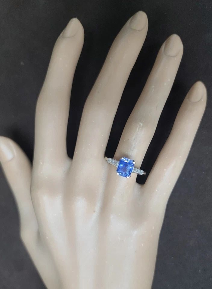 VINTAGE 14K WHITE GOLD ENGAGEMENT RING 2.20CT. NATURAL BLUE SAPPHIRE RADIANT CUT: VINTAGE 14K WHITE GOLD ENGAGEMENT RING 2.20CT. NATURAL BLUE SAPPHIRE RADIANT CUT This stunning 14k white gold ring features a magnificent 2.20ct natural blue sapphire in a radiant cut, accented by spa