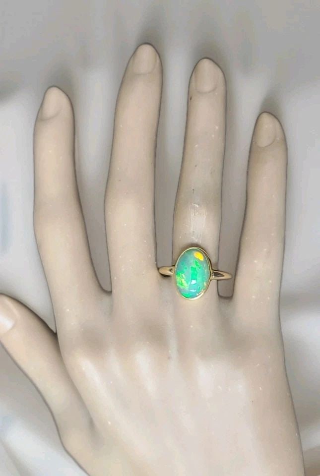 VINTAGE 14K-22K YELLOW GOLD 4.25CT. NATURAL AFRICA OPAL ENGAGEMENT BEZEL RING: VINTAGE 14K-22K YELLOW GOLD 4.25CT. NATURAL AFRICA OPAL ENGAGEMENT BEZEL RING There is something almost mystical about an opal… A stone that carries a rainbow within it. This enchanting vintage ring