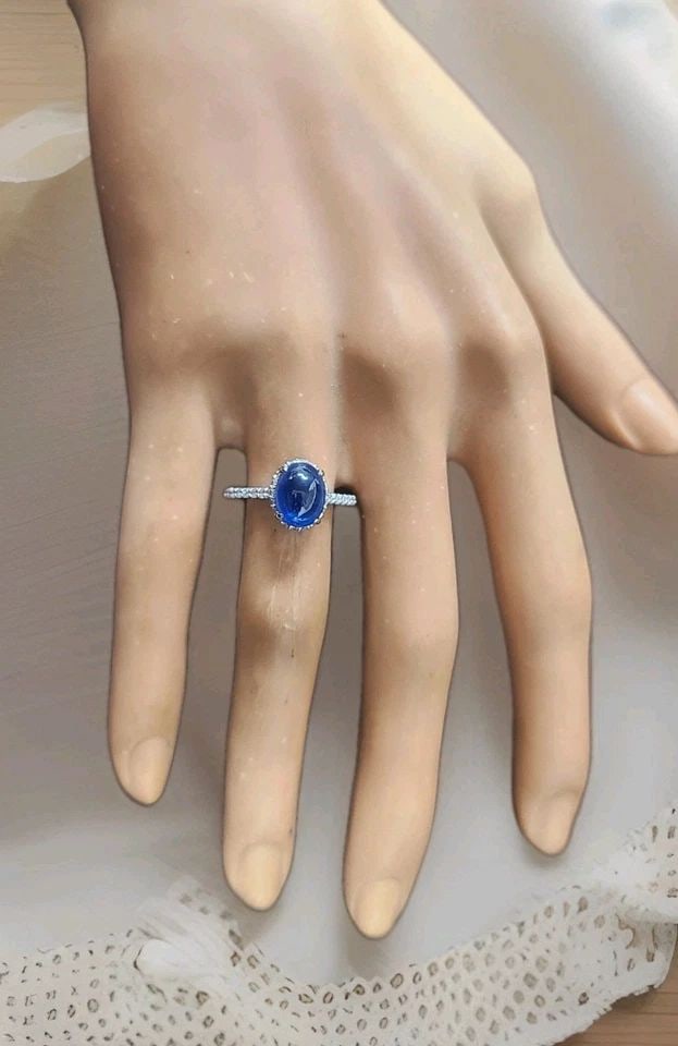 3.52CT. NATURAL BLUE SAPPHIRE CABOCHON SHAPE VINTAGE PLATINUM ENGAGEMENT RING: 3.52CT. NATURAL BLUE SAPPHIRE CABOCHON SHAPE VINTAGE PLATINUM ENGAGEMENT RING This stunning platinum engagement ring features a natural heated blue sapphire in an elegant cabochon cut, weighing 3.52 c