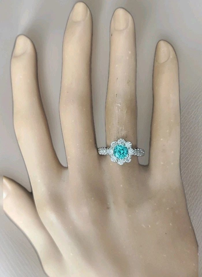 VINTAGE 14K WHITE GOLD ENGAGEMENT RING 1.32CT. BLUE NEON TOURMALINE ROUND CUT: VINTAGE 14K WHITE GOLD ENGAGEMENT RING 1.32CT. BLUE NEON TOURMALINE ROUND CUT Gorgeous vintage engagement ring crafted in 14K white gold, featuring a stunning round neon blue lab-grown tourmaline weig