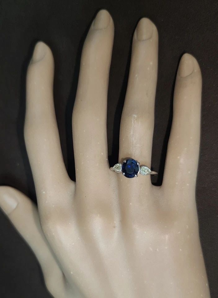 VINTAGE 14K WHITE GOLD ENGAGEMENT RING1.99CT.NATURAL BLUE OVAL SAPPHIRE GIA CERT: VINTAGE 14K WHITE GOLD ENGAGEMENT RING 1.99CT. NATURAL BLUE SAPPHIRE GIA CERT This exquisite 14k white gold engagement ring features a stunning 1.99ct natural blue sapphire, certified by GIA. The oval