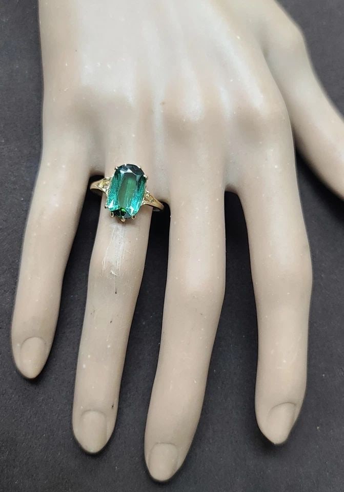 VINTAGE 14K YELLOW GOLD ENGAGEMENT RING 3.87CT. NATURAL GREEN TOURMALINE: VINTAGE 14K YELLOW GOLD ENGAGEMENT RING 3.87CT. NATURAL GREEN TOURMALINE This vintage 14k yellow gold engagement ring features a stunning 3.87CT natural green tourmaline as the main stone. The cushion