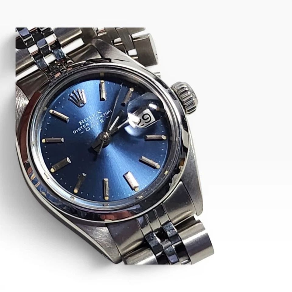 ROLEX LADIES DATE 26 MM BLUE DIAL JUBILEE STEEL AUTOMATIC WATCH 6916 CIRCA 1973: ROLEX LADIES DATE 26 MM BLUE DIAL JUBILEE STEEL AUTOMATIC WATCH 6916 CIRCA 1973 Manufacturer Rolex Category Oyster Perpetual Ladies Date Reference Number 6916 Band Stainless Steel Band Color Steel Ban