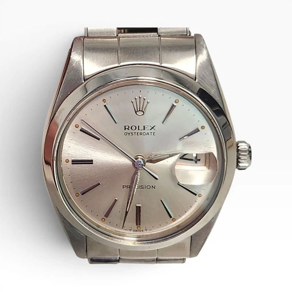 ROLEX LADIES DATE 26 MM STEEL WHITE ROMAN OYSTER AUTOMATIC WATCH 6916 CIRCA 1973: ROLEX LADIES DATE 26 MM STEEL WHITE ROMAN OYSTER AUTOMATIC WATCH Manufacturer Rolex Category Oyster Perpetual Ladies Date Reference Number 6916 Band Stainless Steel Band Color Steel Band Type Oyster B
