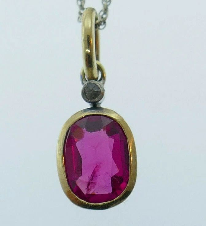 14K YELLOW GOLD SYNTHETIC RUBY WHITE GOLD CHAIN NECKLACE: 14K YELLOW GOLD SYNTHETIC RUBY WHITE GOLD CHAIN NECKLACE 14k white gold chain necklace with a 14k yellow gold synthetic ruby Measurements: the chain is 1/16" W x 17" L; the pendant is 1/4" W x 3/4" L 