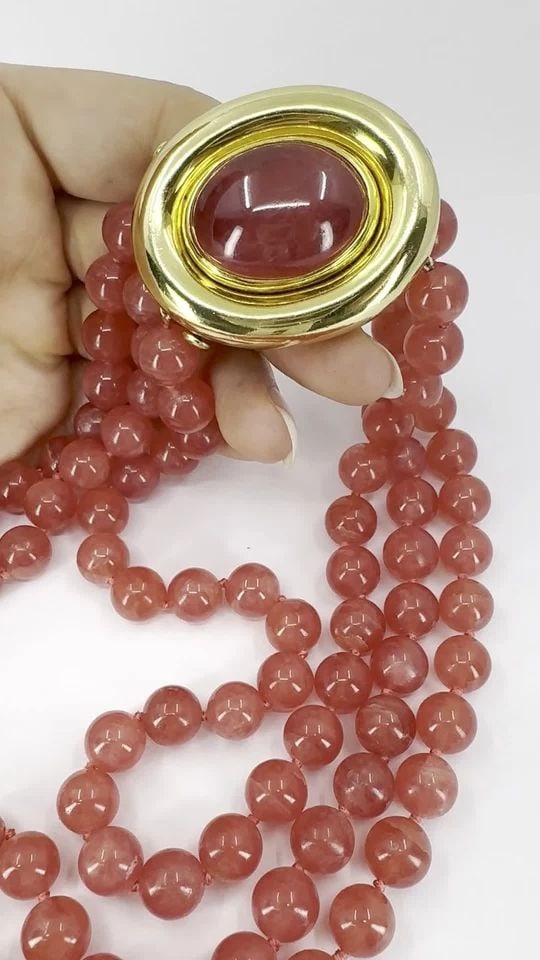 VINTAGE PALOMA PICASSO TIFFANY & CO. 18K GOLD PINK RHODOCHROSITE BEADED NECKLACE: VINTAGE PALOMA PICASSO TIFFANY & CO. 18K GOLD PINK RHODOCHROSITE BEADED NECKLACE This vintage Tiffany & Co. Paloma Picasso necklace features three strands of polished pink rhodochrosite beads, accente