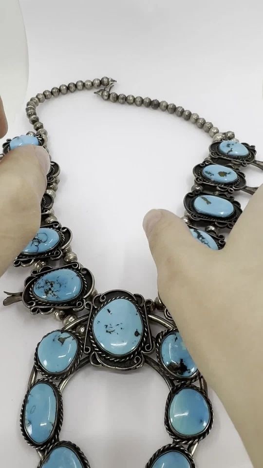 NAVAJO NATIVE INDIAN STERLING SILVER TURQUOISE SQUASH BLOSSOM NECKLACE: NAVAJO NATIVE INDIAN STERLING SILVER TURQUOISE SQUASH BLOSSOM NECKLACE KL JUTO This striking Navajo squash blossom necklace is crafted in sterling silver and set with vivid blue turquoise cabochons, e