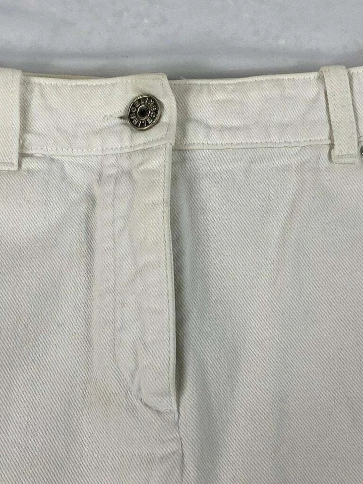 CELINE WHITE DENIM MINI SKIRT, SIZE 40: CELINE WHITE DENIM MINI SKIRT, SIZE 40 CELINE WHITE DENIM MINI SKIRT, SIZE 40 The skirt features floral cut offs on the bottom of the skirt, mini length and silver tone hardware. Length: 15.5 in. (39.