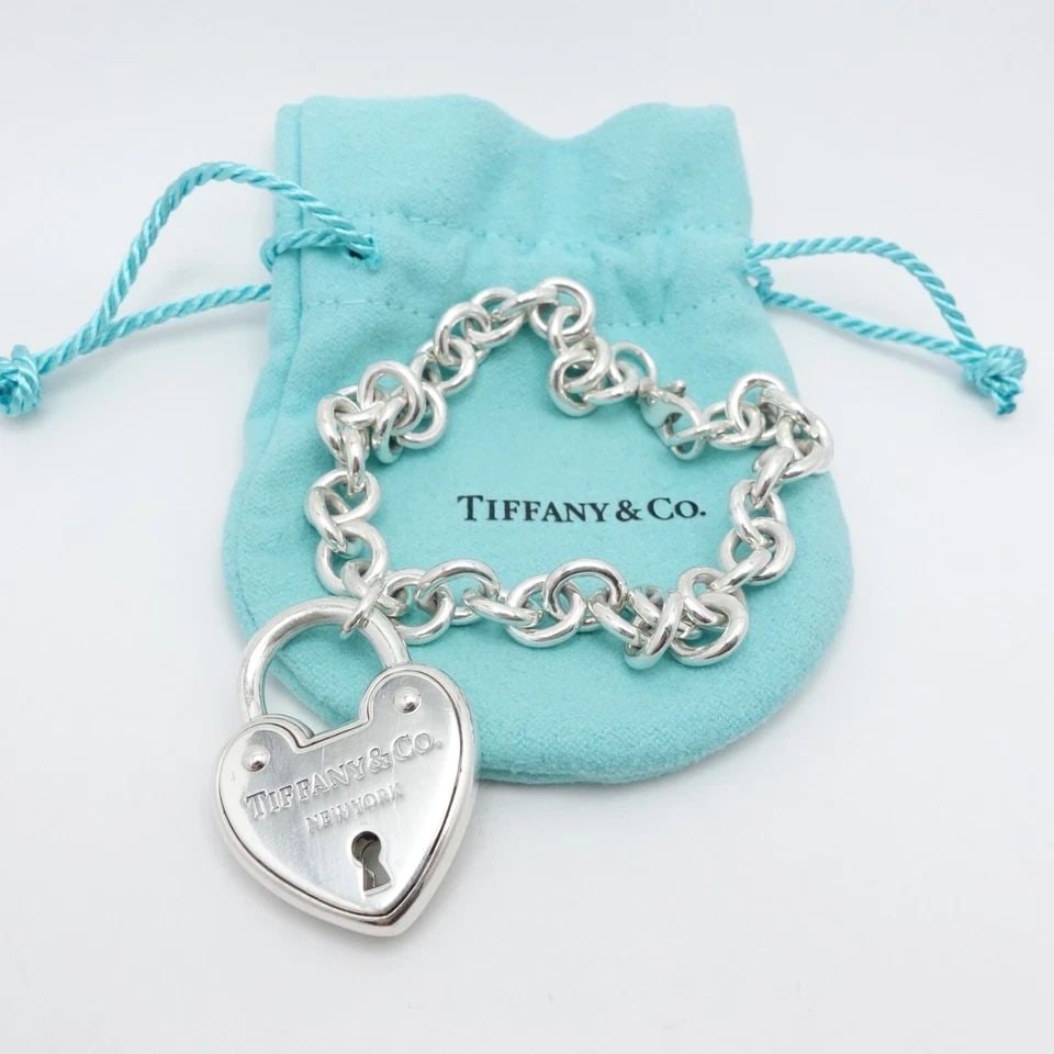 TIFFANY & CO. STERLING SILVER HEART PADLOCK CHAIN BRACELET SIZE 9" LONG POUCH: Tiffany & Co. Sterling Silver Large Heart Padlock Chain Bracelet Size - 9" Long Fits up to Relax 8" - 8.25" Snug Fit Chain Width - 8mm Charm Height - 1.33" Charm Width - 1" approx. Charm Depth - 5.5mm