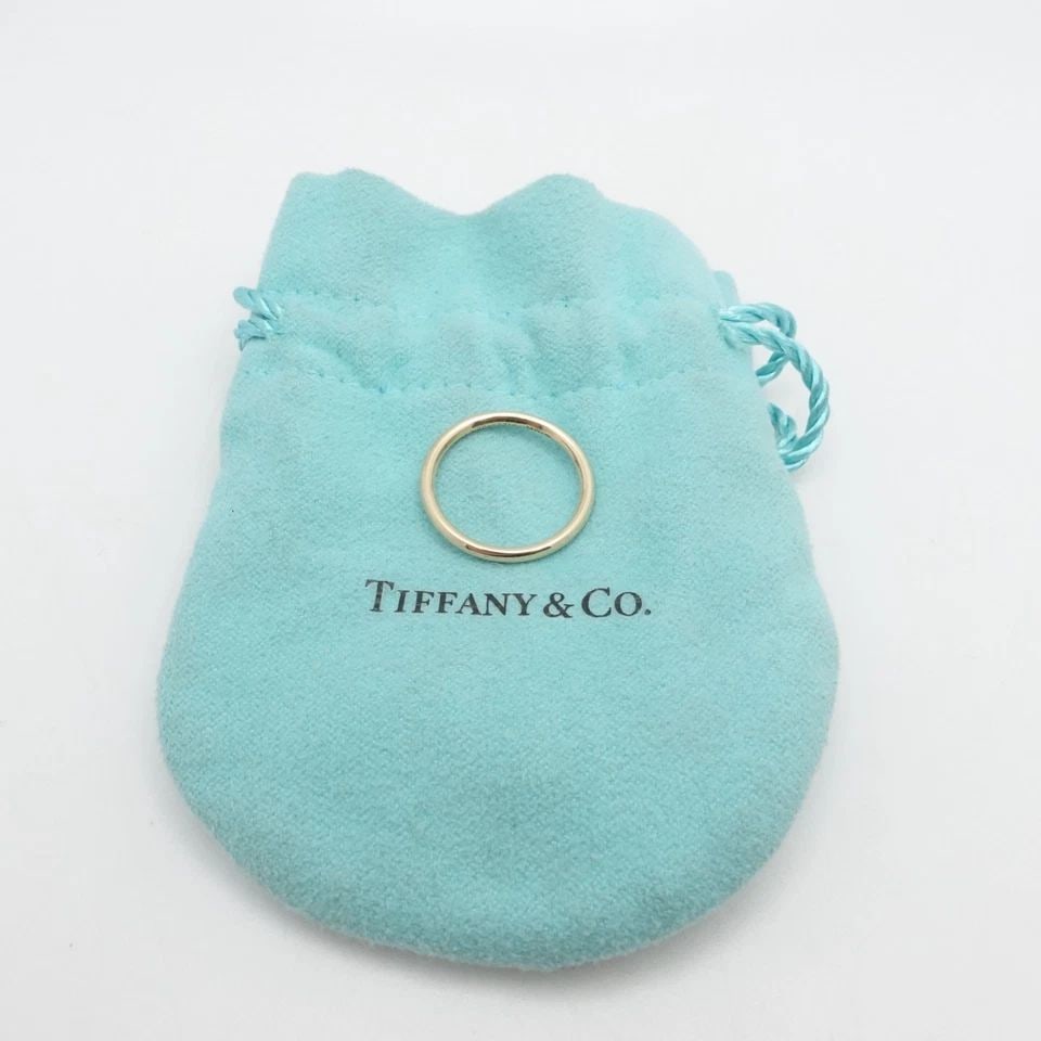 TIFFANY & CO. 18K YELLOW GOLD WEDDING THIN BAND RING SIZE 5.5: TIFFANY & CO. 18K YELLOW GOLD WEDDING THIN BAND RING SIZE 5.5 Tiffany & Co. 18K Yellow Gold Wedding Band Size - 5.5 Band Width - 1.7mm est Total Weight - 1.9 Grams Hallmark -18K TIFFANY & Co. Excellen