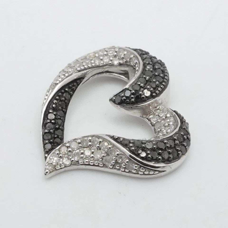 STERLING SILVER BLACK AND WHITE PAVE DIAMOND OPEN HEART SLIDE PENDANT: STERLING SILVER BLACK AND WHITE PAVE DIAMOND OPEN HEART SLIDE PENDANT Sterling Silver Pave Black Diamond Open Heart Pendant Length - 18mm Width - 20.5mm Bail Width - 2mm Total Weight - 2.6 Grams Great