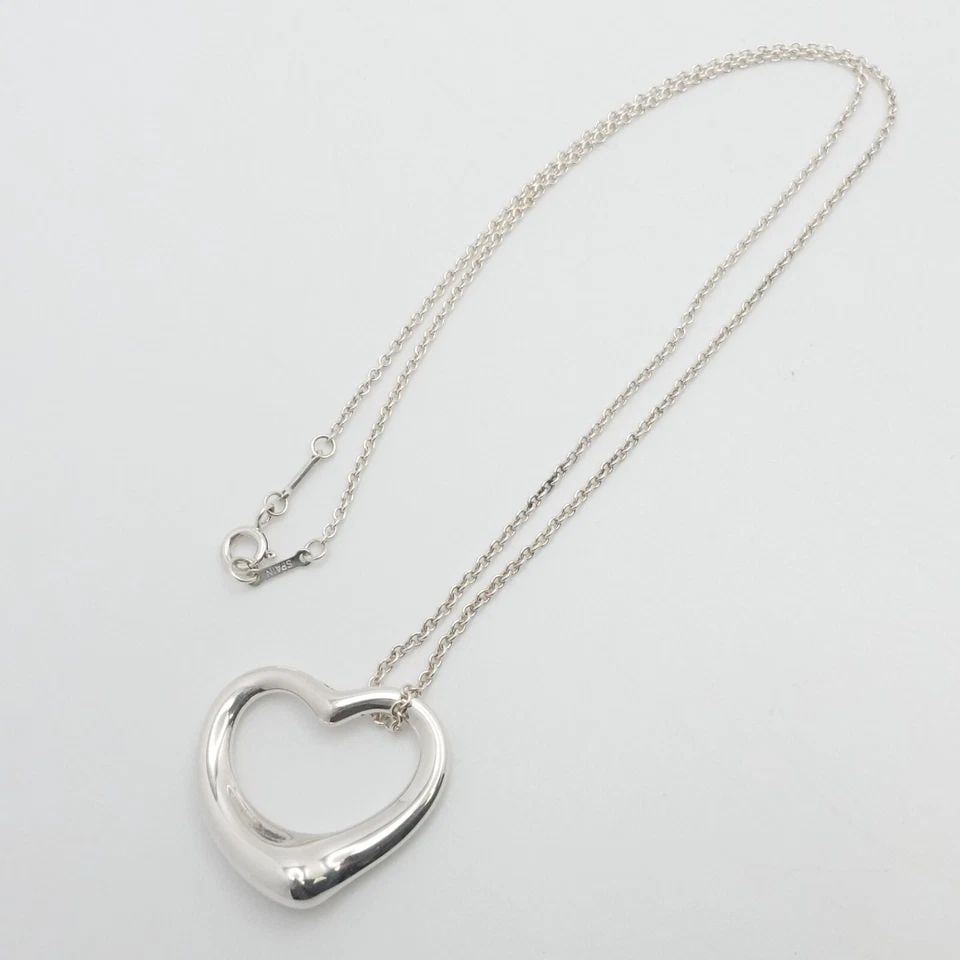 TIFFANY & CO. PERETTI STERLING SILVER 27MM OPEN HEART PENDANT NECKLACE 18" POUCH: Tiffany & Co. Elsa Peretti Sterling Silver Open Heart Medium Pendant Necklace Length - 18" Long Chain Width - 1.5mm Pendant Width - 27mm Est. Retail Price - $700 USD + Tax Total Weight - 10 Grams Hall
