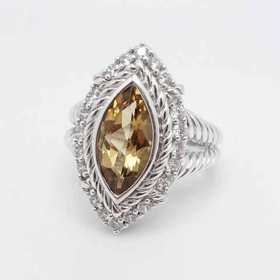 JUDITH RIPKA STERLING SILVER MARQUISE CITRINE &CLEAR CZ COCKTAIL RING 9.25: Judith Ripka Sterling Silver Marquise Citrine Clear Cubic Zirconia Split Shank Halo Ring Size - 9.25 Band Width - 3mm Height - 25mm Width - 15mm Gemstone Size - 16.5mm x 8.5mm Total Weight - 10 Grams 