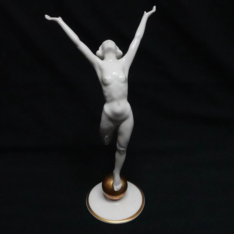 HUTSCHENREUTHER NUDE WOMAN STANDING ON GOLD BALL PORCELAIN FIGURINE - 8.5" TALL: HUTSCHENREUTHER NUDE WOMAN STANDING ON GOLD BALL PORCELAIN FIGURINE - 8.5" TALL Hutschenreuther Kunstabteilung Germany Nude Woman Standing On Gold Ball Art Deco Style Porcelain Figurine by Artist Karl