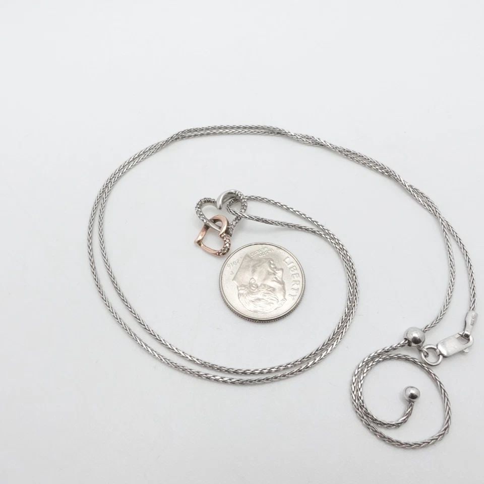 STERLING SILVER TWO TONE DOUBLE HEART DIAMOND CHARM ADJUSTABLE NECKLACE 23.5": STERLING SILVER TWO TONE DOUBLE HEART DIAMOND CHARM ADJUSTABLE NECKLACE 23.5" Sterling Silver & Rose Gold Two Tone Double Heart Diamond Charm Adjustable Necklace Length - 23.5" Long Chain Width - 1mm 