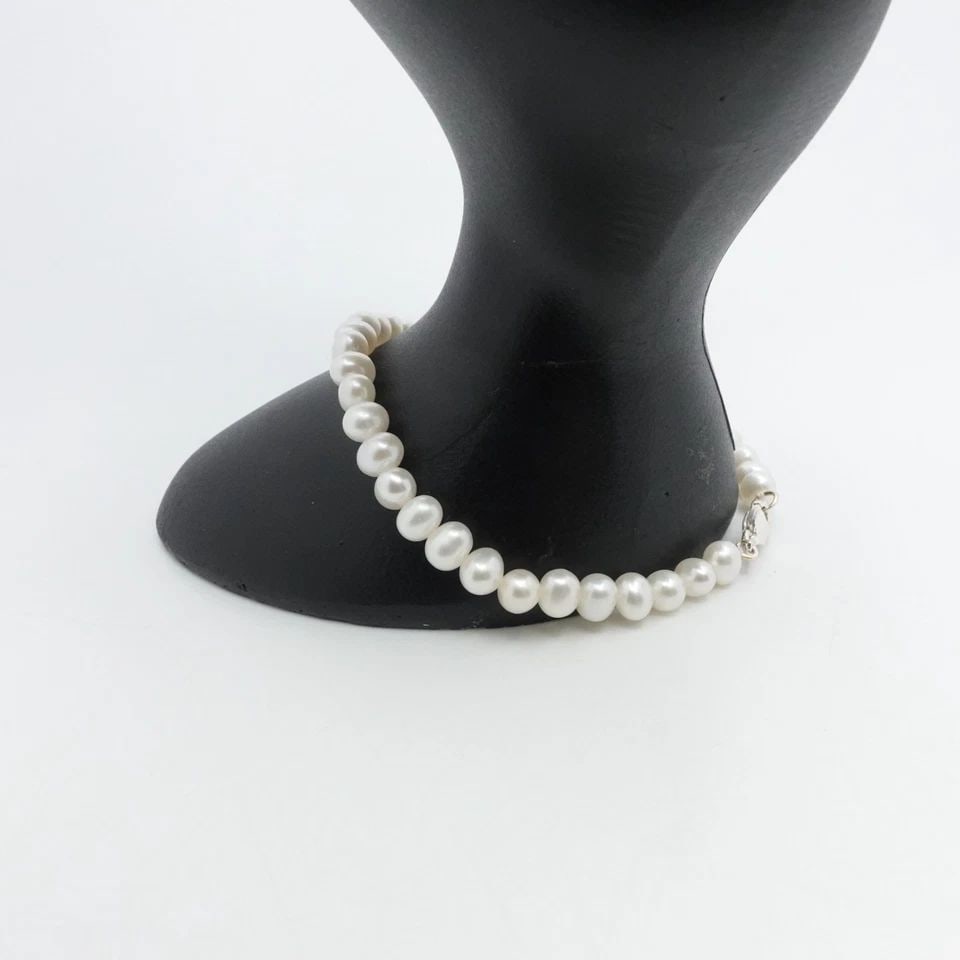 STERLING SILVER WHITE BAROQUE CULTURED PEARL CORD BRACELET 7.5" LONG: STERLING SILVER WHITE BAROQUE CULTURED PEARL CORD BRACELET 7.5" LONG Sterling Silver White Baroque Cultured Pearl Cord Bracelet Length - 7.5" Long Wrist - 7" Pearl Width - 5.5mm Total Weight - 7.4 Gra