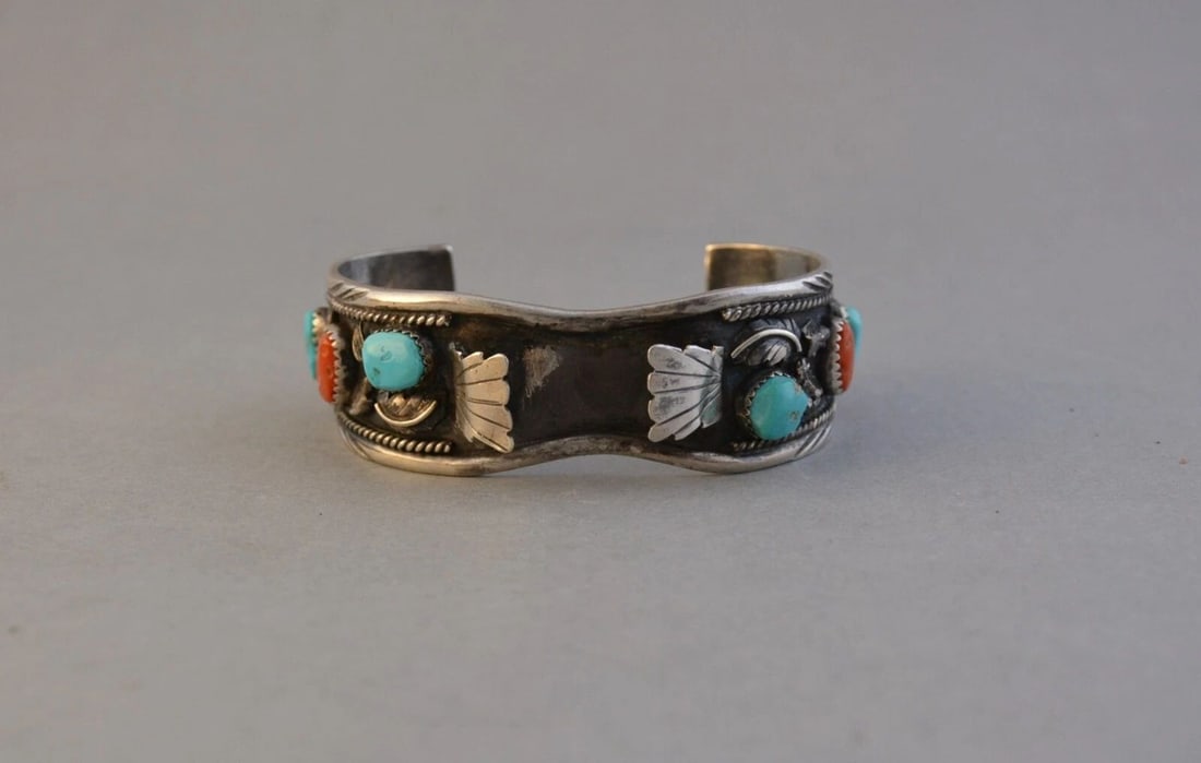 VINTAGE NAVAJO STERLING SILVER WATCHBAND BRACELET - TURQUOISE CORAL - 6 1/2": VINTAGE NAVAJO STERLING SILVER WATCHBAND BRACELET - TURQUOISE CORAL - 6 1/2" This vintage Navajo silver watchband cuff bracelet has 4 turquoise stones with 2 pieces of coral and silver applique. The b